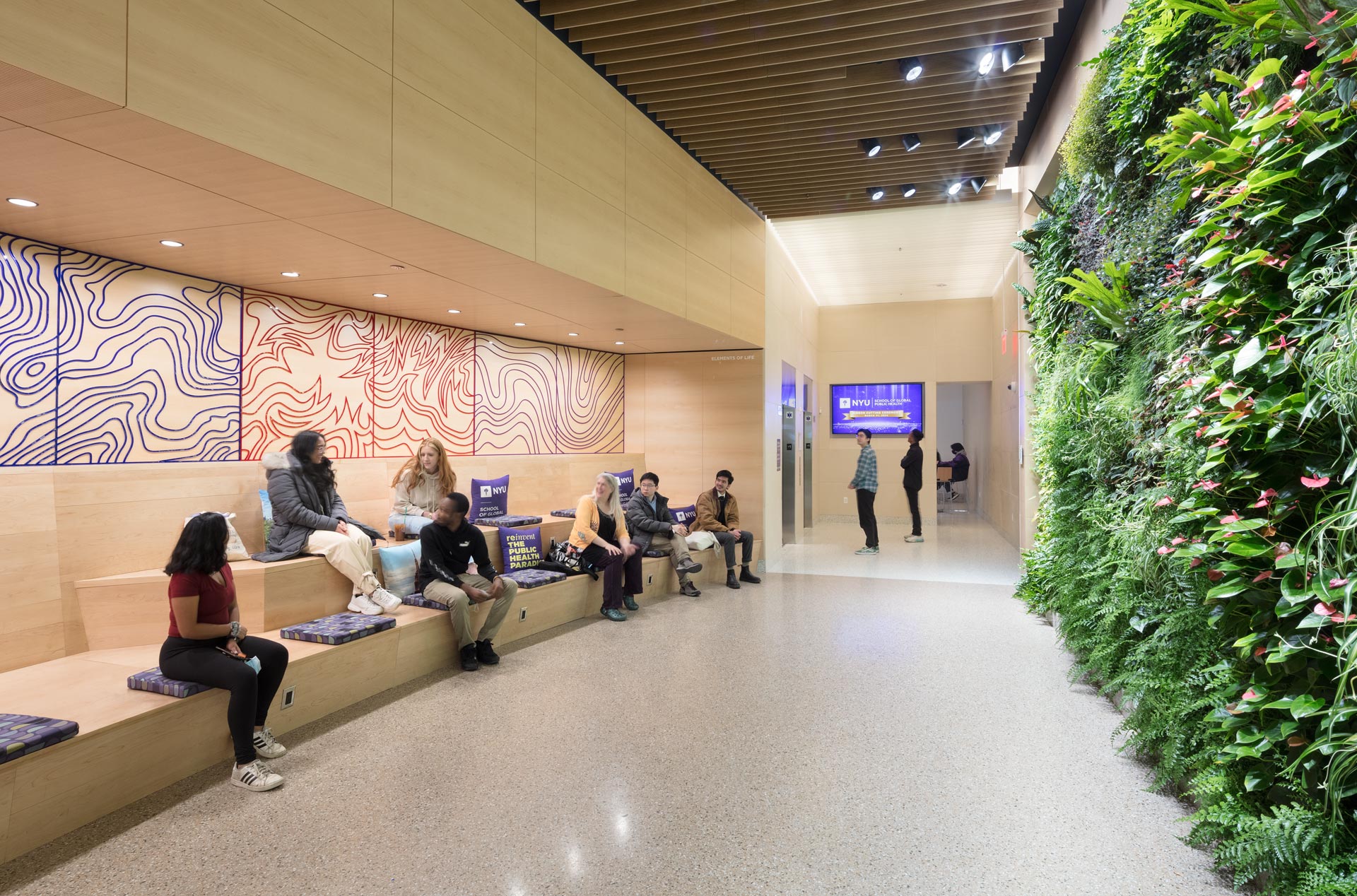 Students in GPH lobby next to the living green wall
