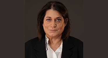Headshot of Professor Judith Weissman with dark gray background