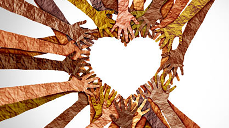 Image of several hands of different colors joining together to form a heart