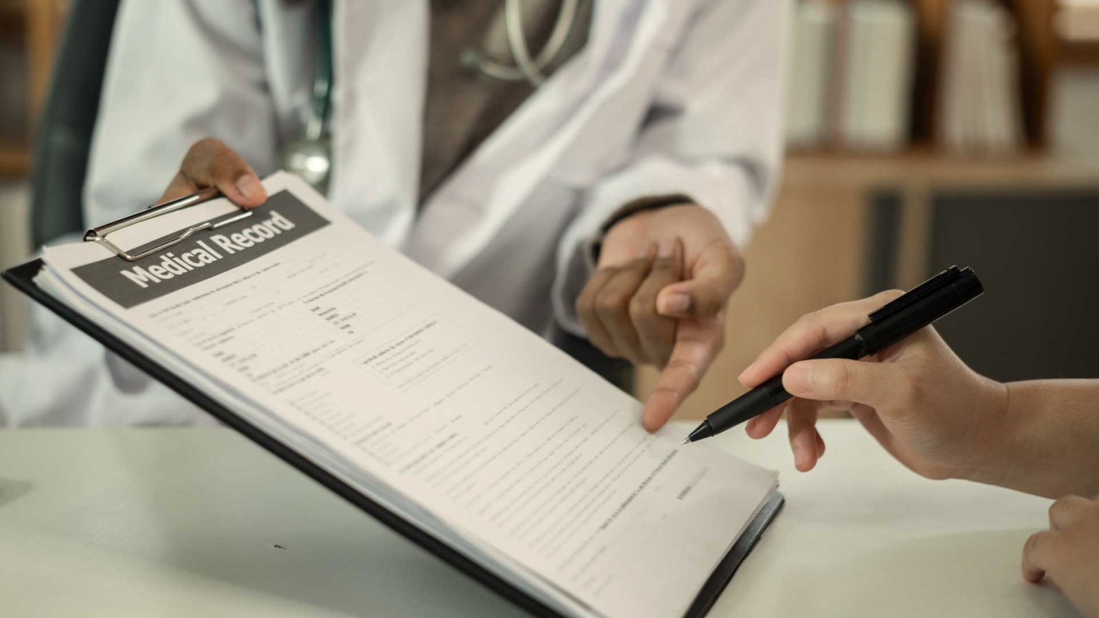 doctor helping patient fill out insurance forms