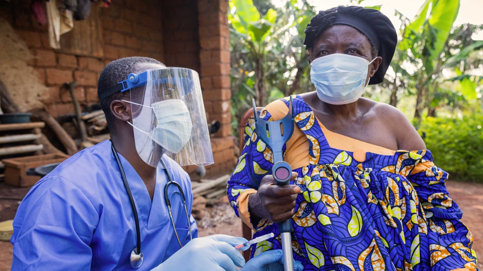 doctor visiting elderly woman in rural village