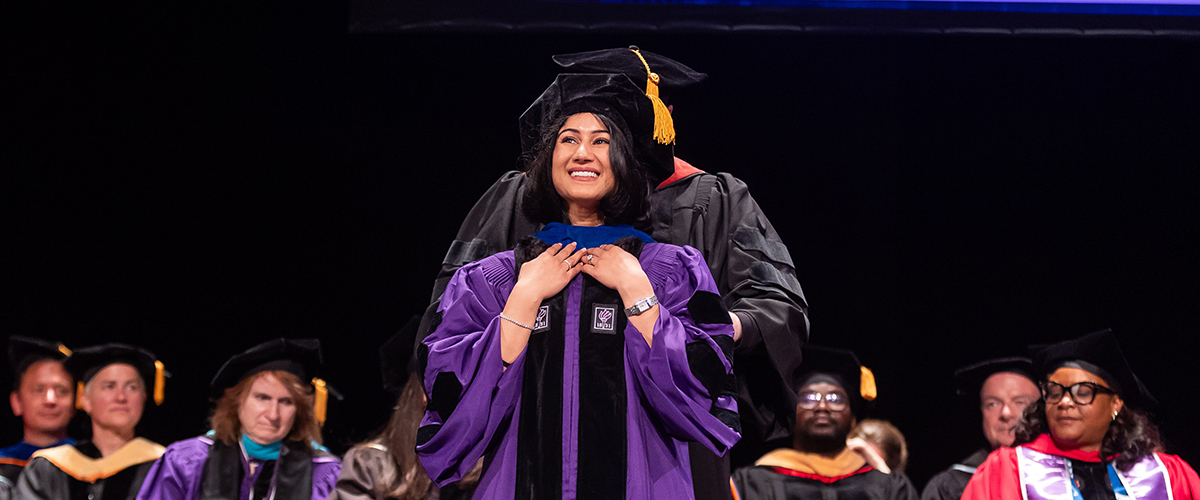 Mahathi Vojjala being hooded by Dr. Raymond Niaura