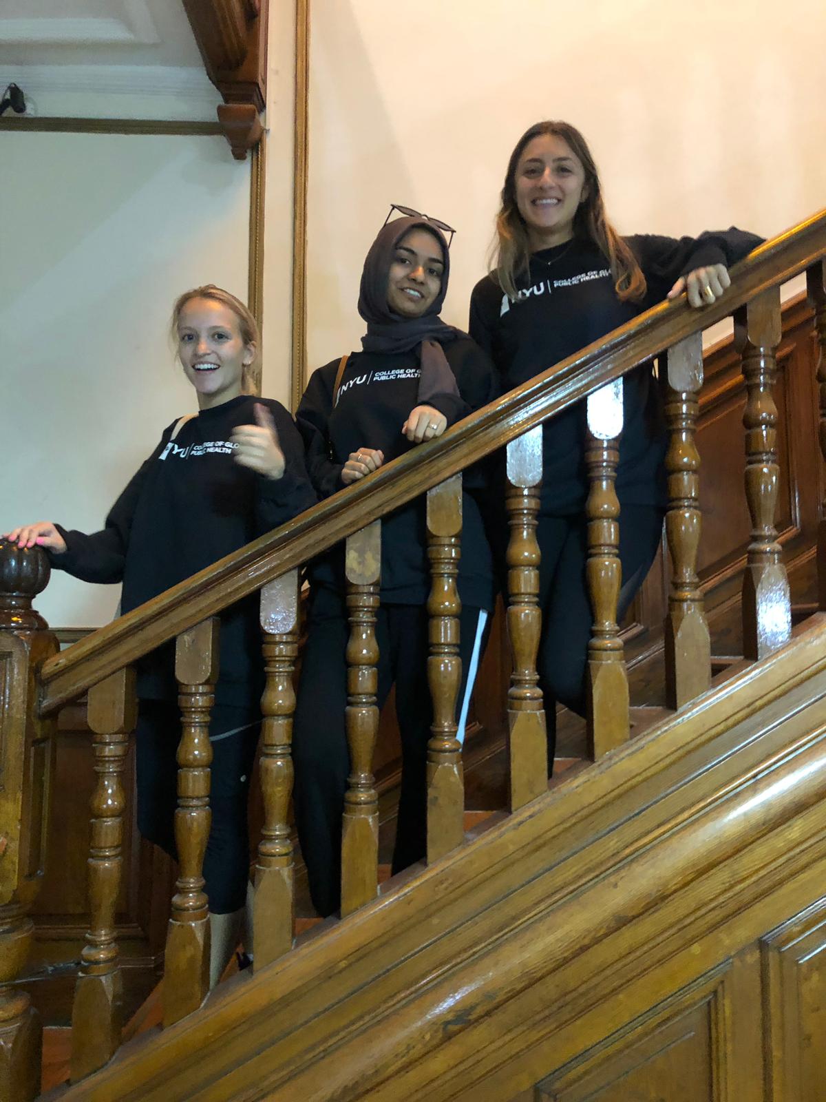 Cohort students with matching sweatshirts after a group presentation 