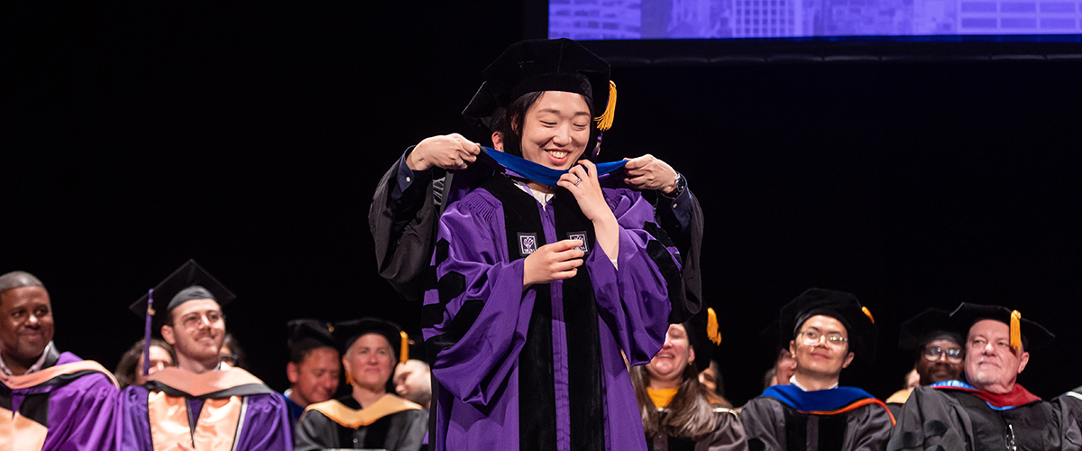 Gawon Cho being hooded by Virginia Chang