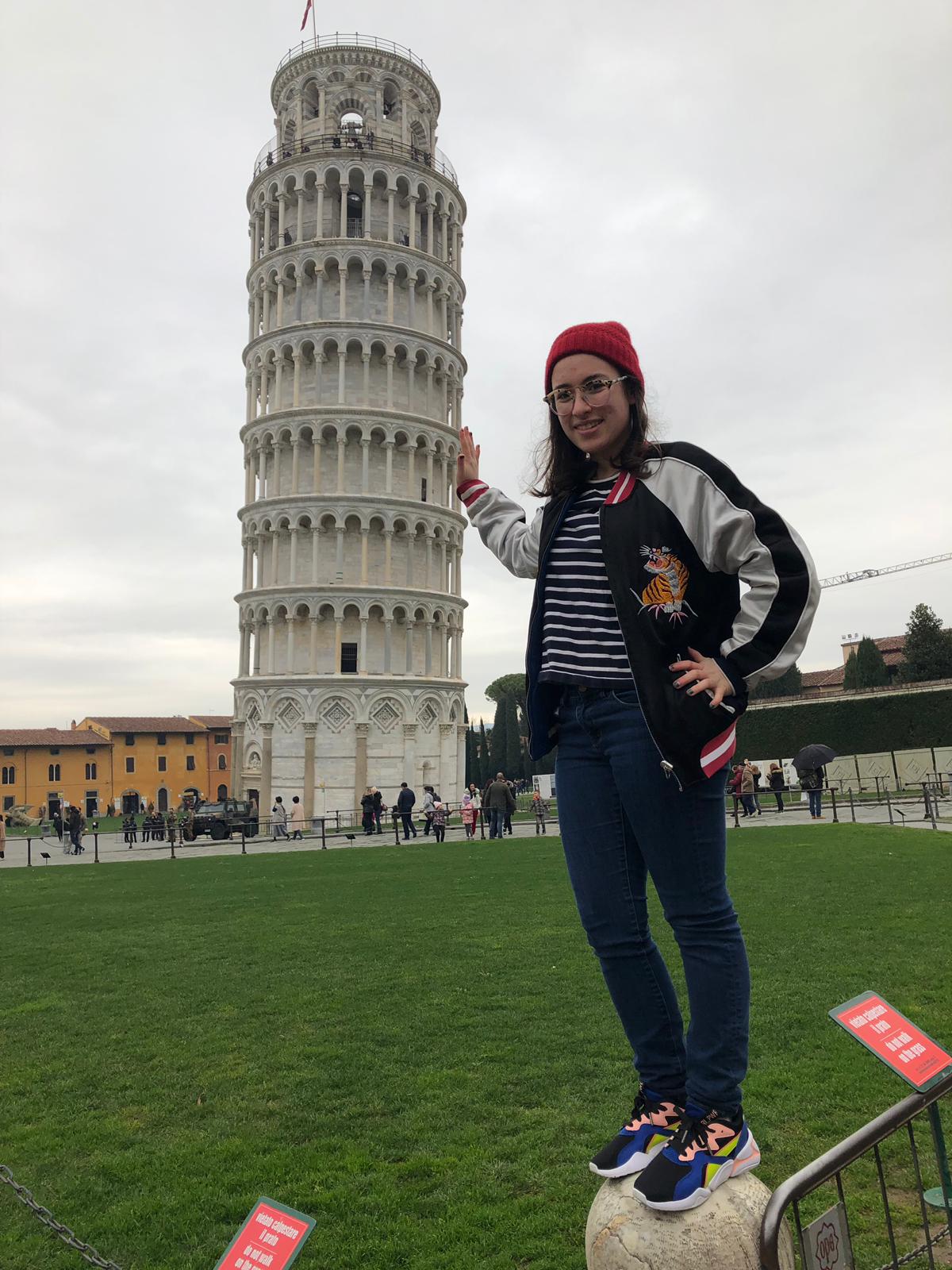 Molly posing with the Leaning Tower of Pisa