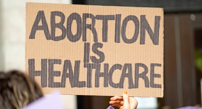 Cardboard sign saying Abortion is Healthcare