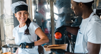 Two chefs working on a food truck