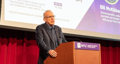 Bill McKibben speaking at the podium.