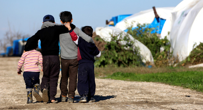 children walking in refugee camp