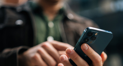 A person typing on their cellphone