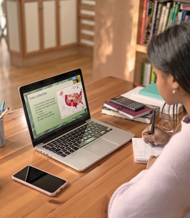 Master of Public Health student watching online lectures on a laptop