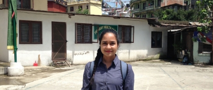 Mehreen in front of a Tibetan settlement office and primary health care clinic.