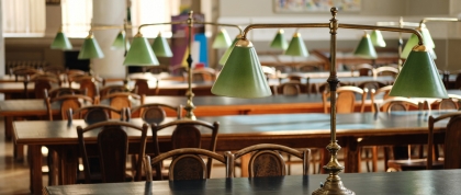 empty desks and chairs in a library reading room