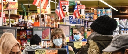 Cashiers wearing protective masks work in a grocery store in Brooklyn, N.Y. Photo by Stephanie Keith