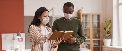 Colleagues talking to each other while wearing a mask