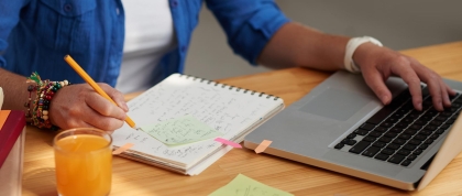 Student writing an essay with a laptop computer