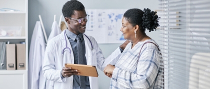 Black doctor speaking with patient