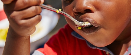 Child eating a spoon of food