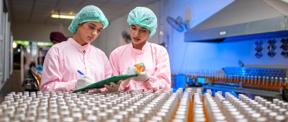 Two workers at a soda processing center