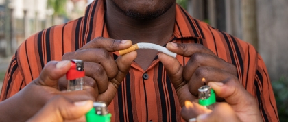 Black American person breaking a cigarette